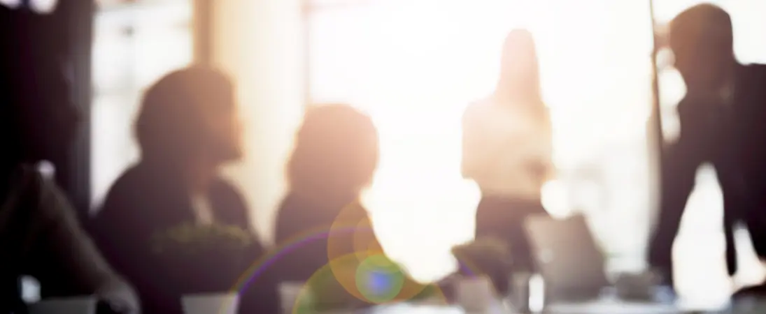 business professionals sitting in a conference room blurred out discussing their business arbitrations and other alternate dispute resolutions